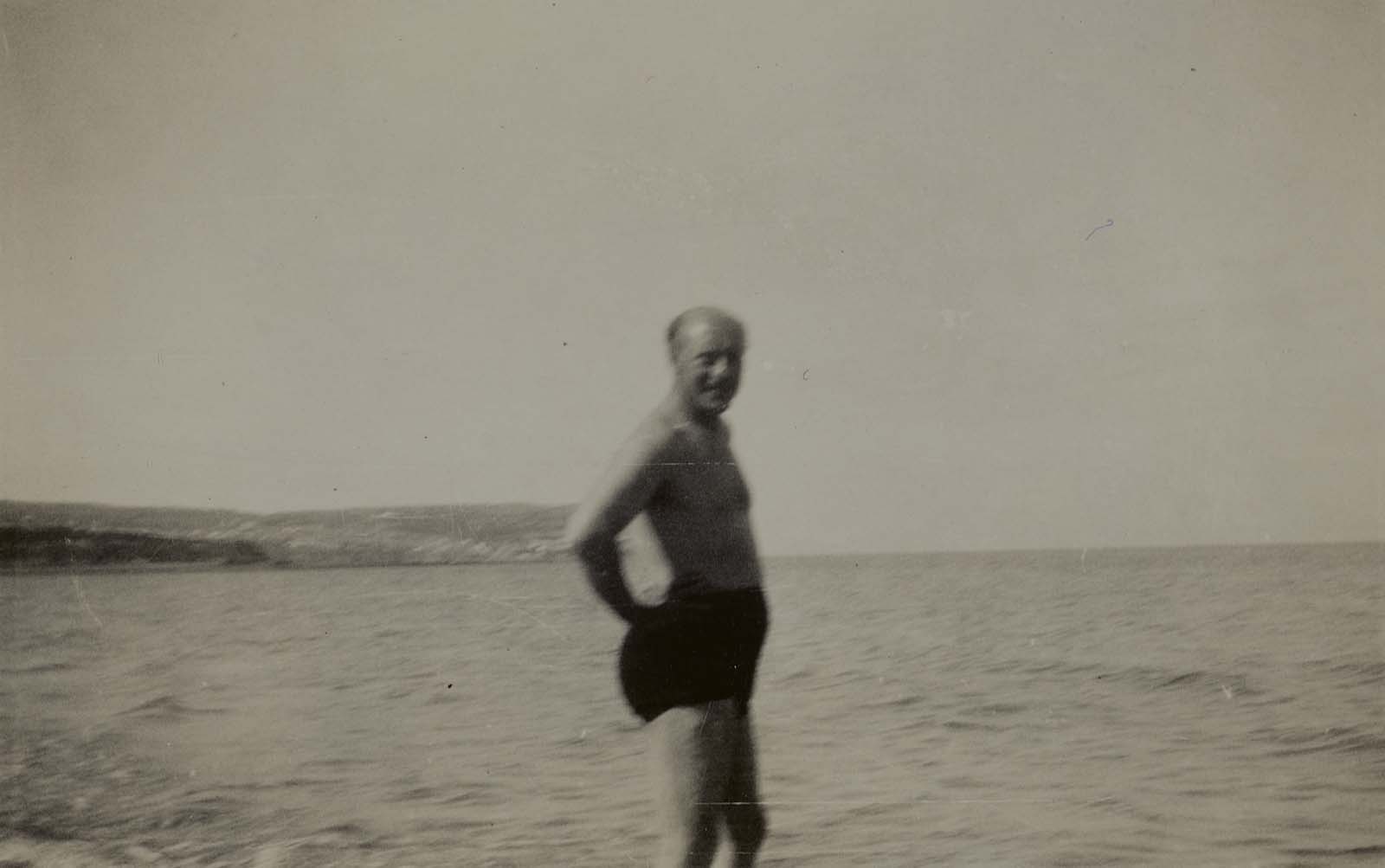 Geoffrey Faber paddling in the sea, Wales, ca. August–September 1933.